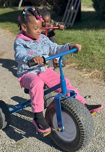 Student on a tricycle.