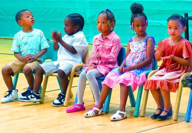 Training Wheels students sitting in chairs.