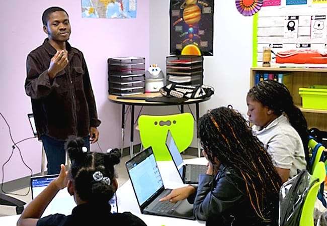 A teacher instructs a class of students.