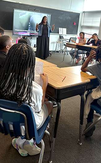 A teacher gives instruction to a class.